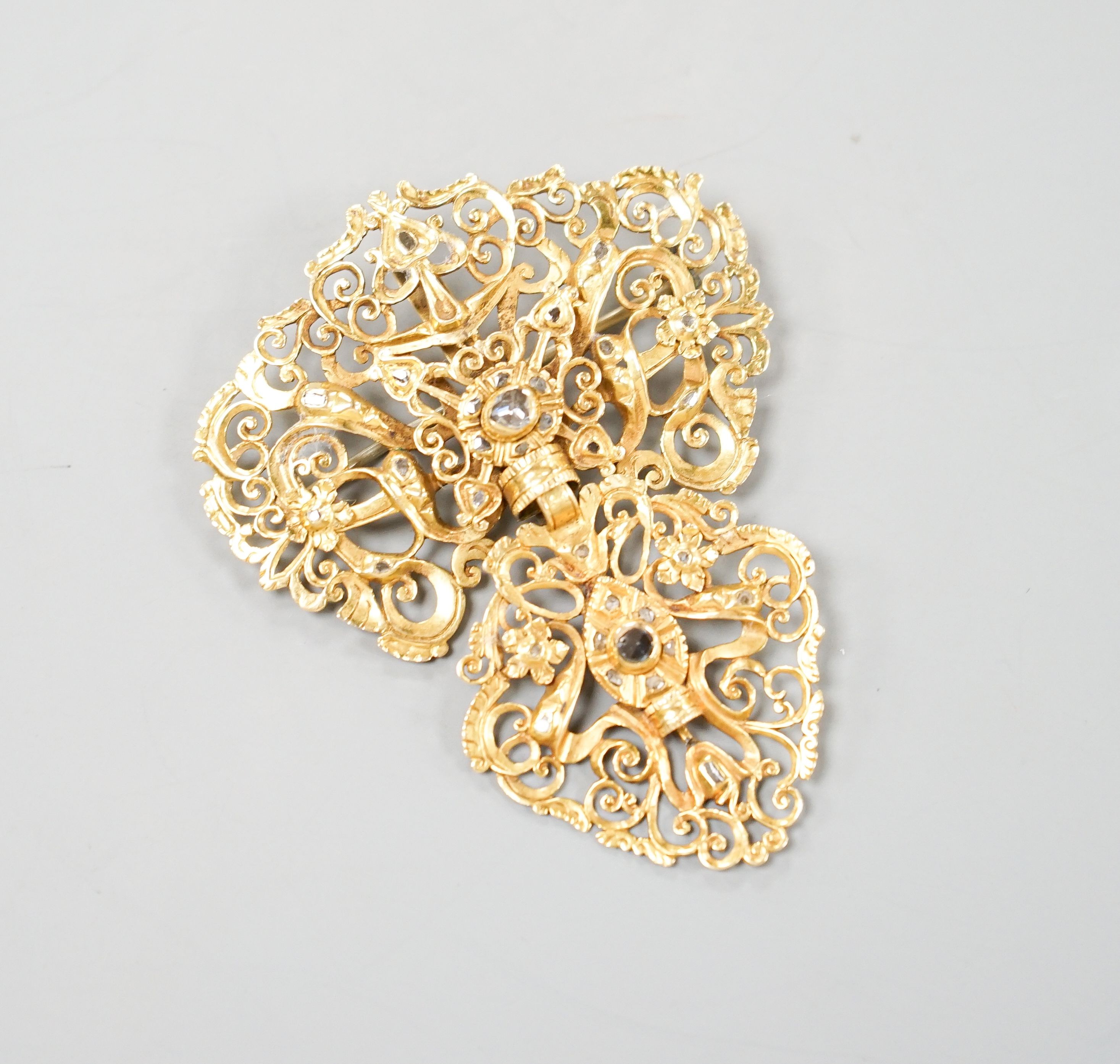 An Indian pierced yellow metal and two stone rose cut diamond set drop pendant brooch, 64mm, gross weight 15.8 grams.